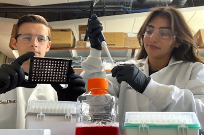 Vogt and Chavez work side by side in lab