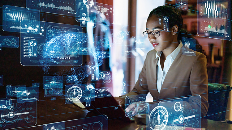 A woman sitting at a computer with AI graphics surrounding her