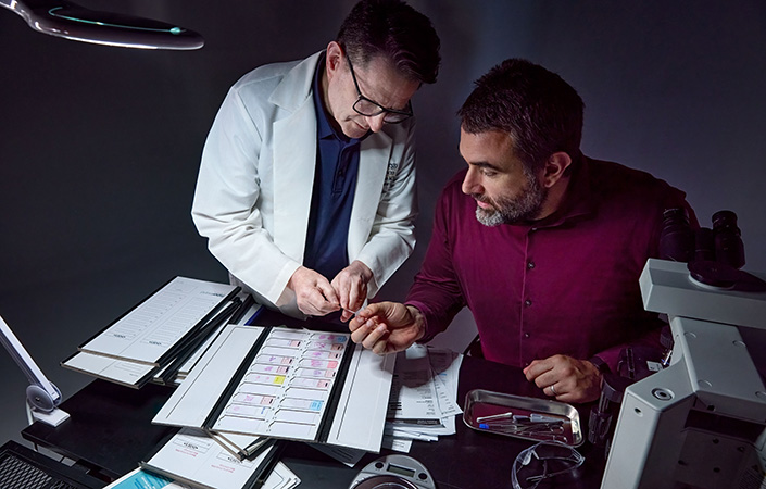 Two researchers look at biopsy slides