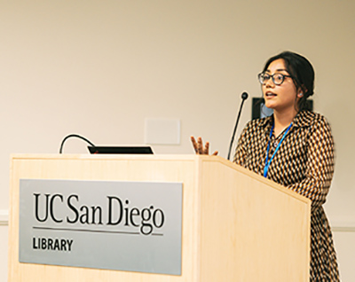 Student Alba Reyes speaks about her internship experience during the anniversary event.