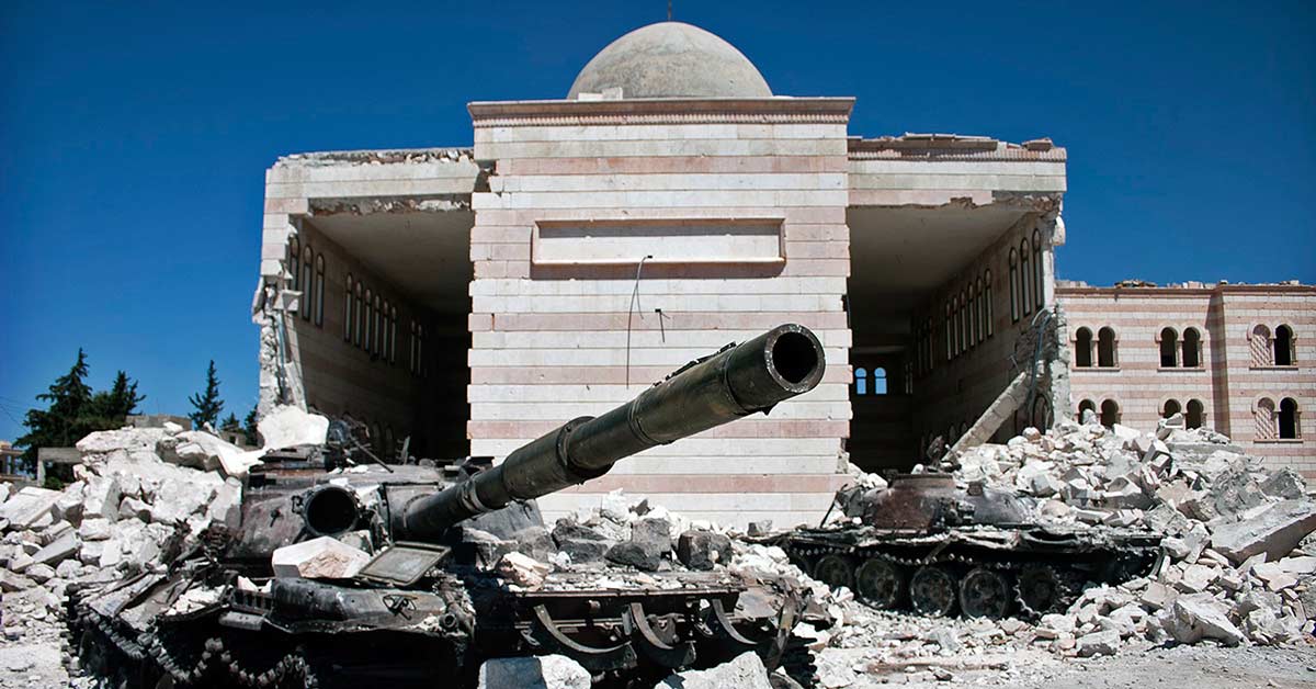 Two destroyed tanks in front of a mosque in Azaz, Syria.