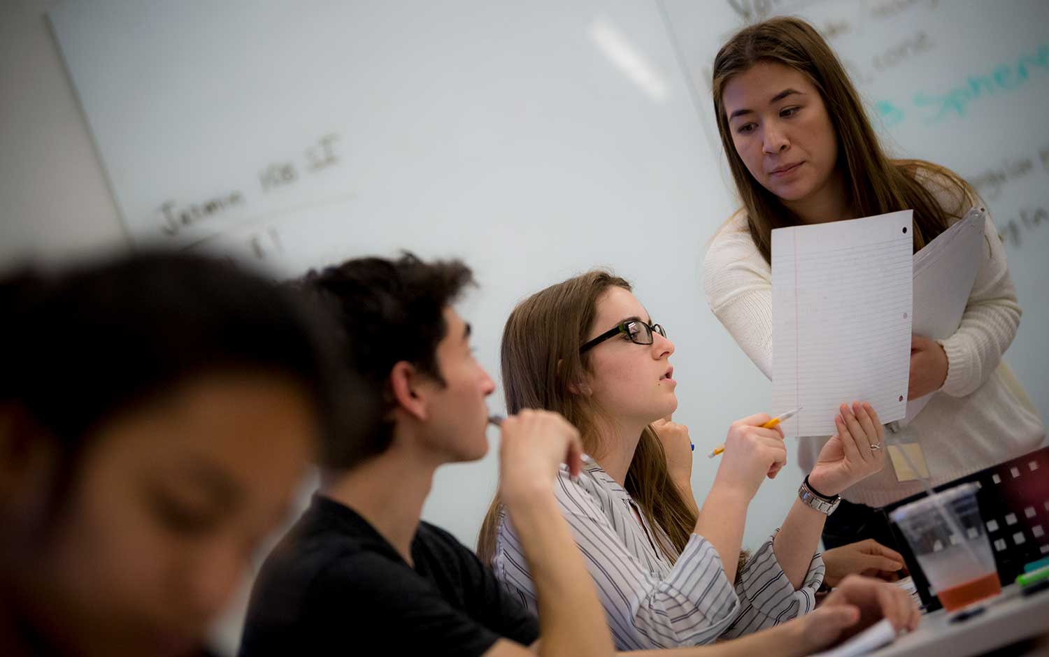 Professor with students in classroom.