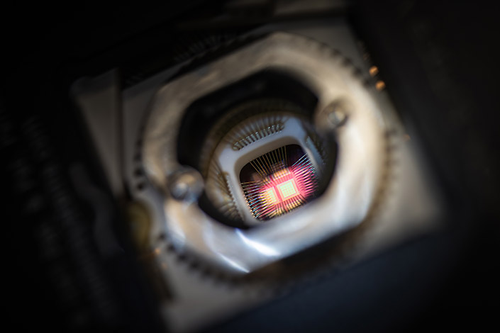 Top-down view looking into a hole containing small electronic chips.