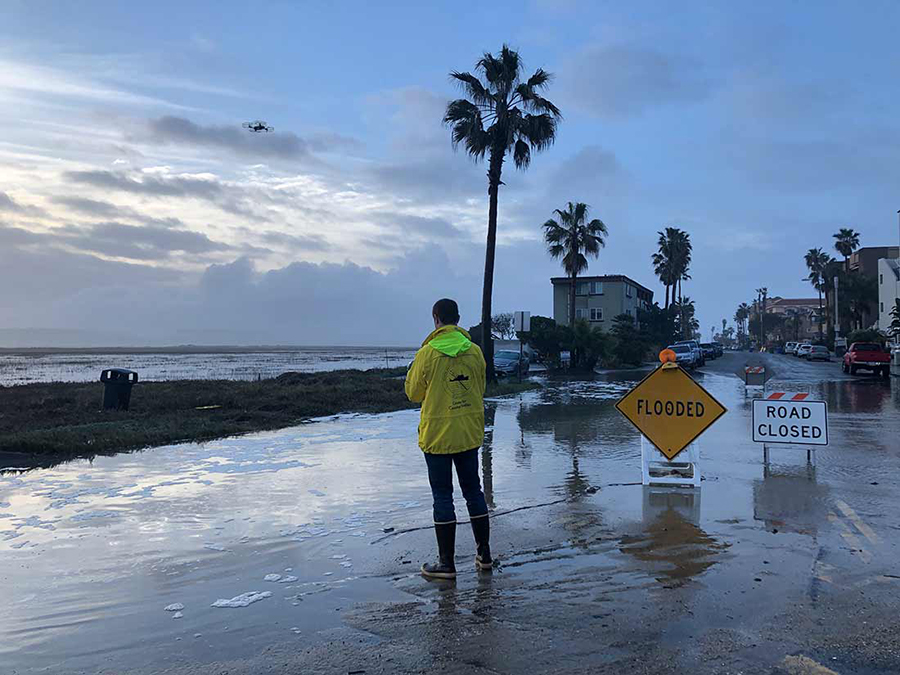 Reporter covering flooding in Imperial Beach.