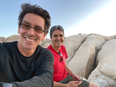 Josh and Akif sitting on a rock in Joshua Tree