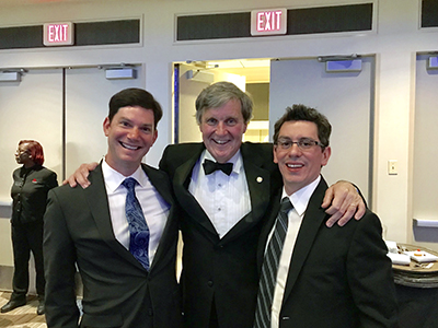 Seth and Josh wearing suits, posing with fellow chemist Cliff Kubiak at awards banquet.