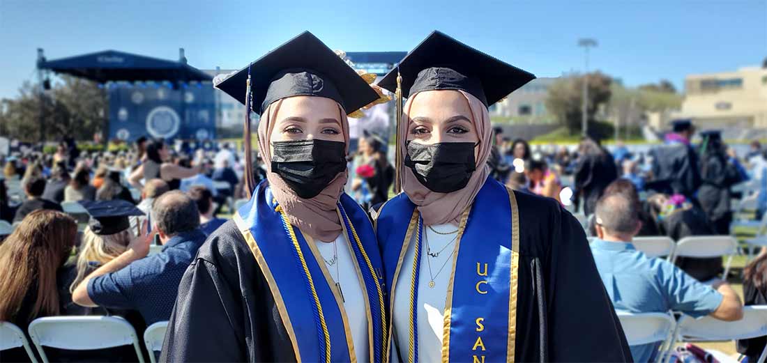 Twins posing for graduation photo