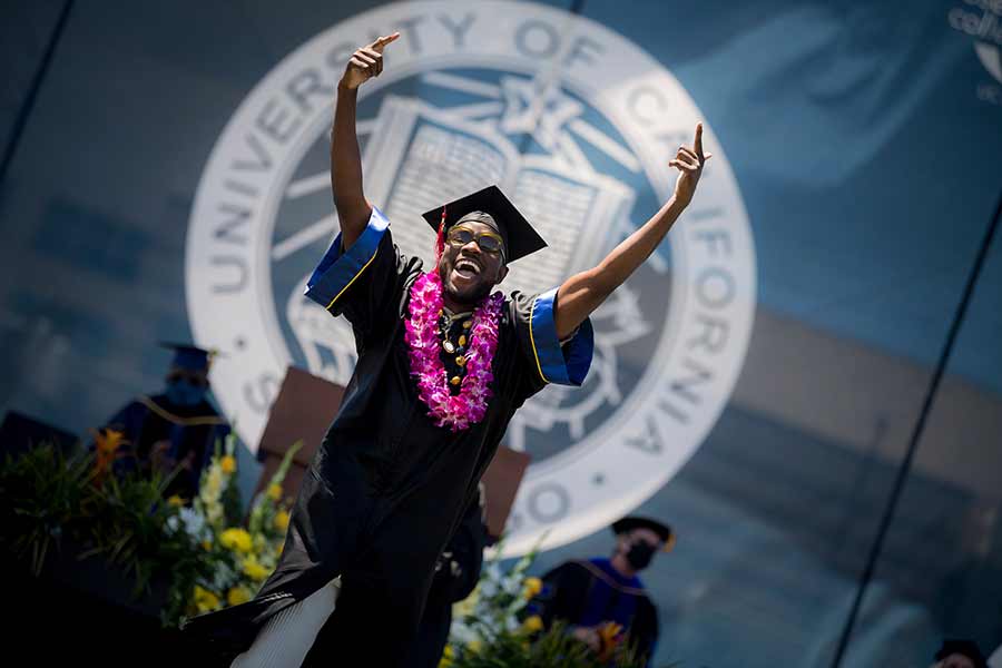 Student walking across graduation stage