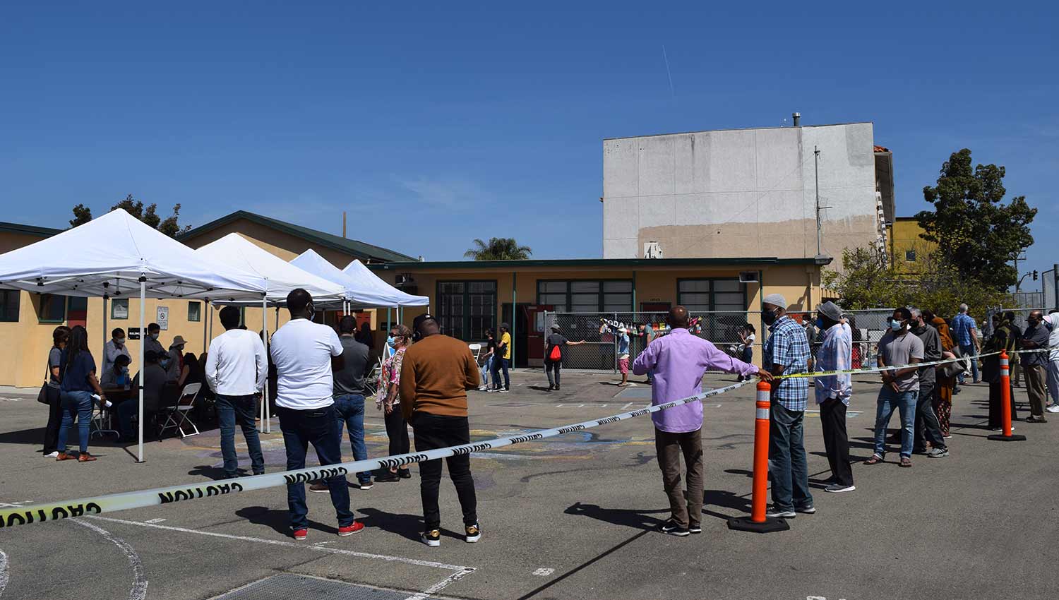 Individuals from refugee community waiting for COVID-19 vaccine.