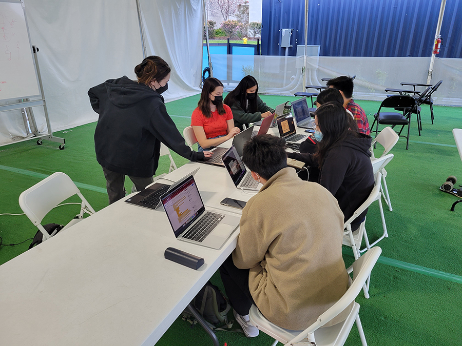 Triton Solar Decathlon team works out in the Return to Learn tents on Warren Mall.