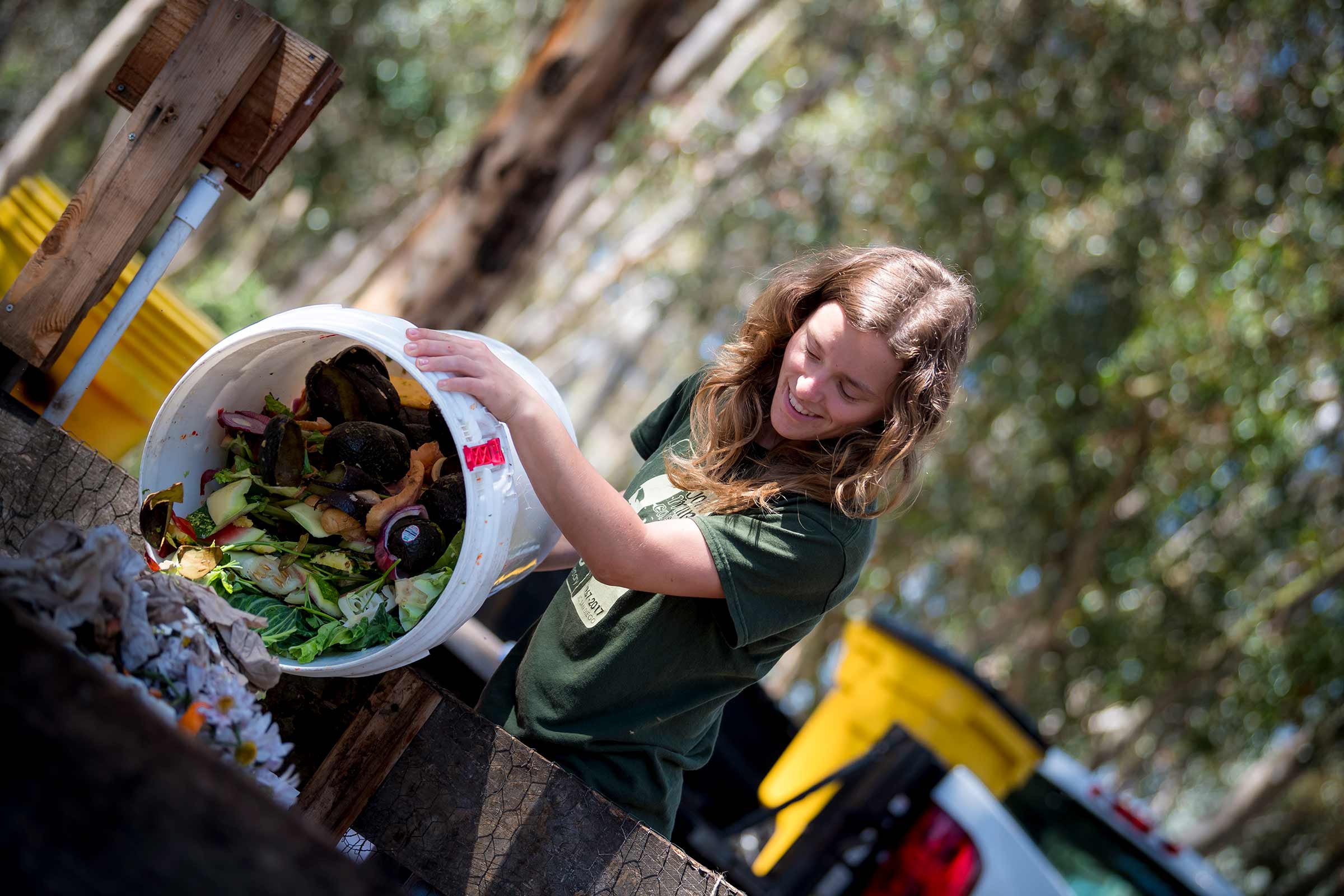 Enid Partika dumping bucket of food waste