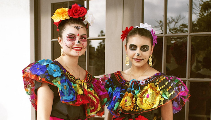 Dancers with painted faces for dia de los muertos