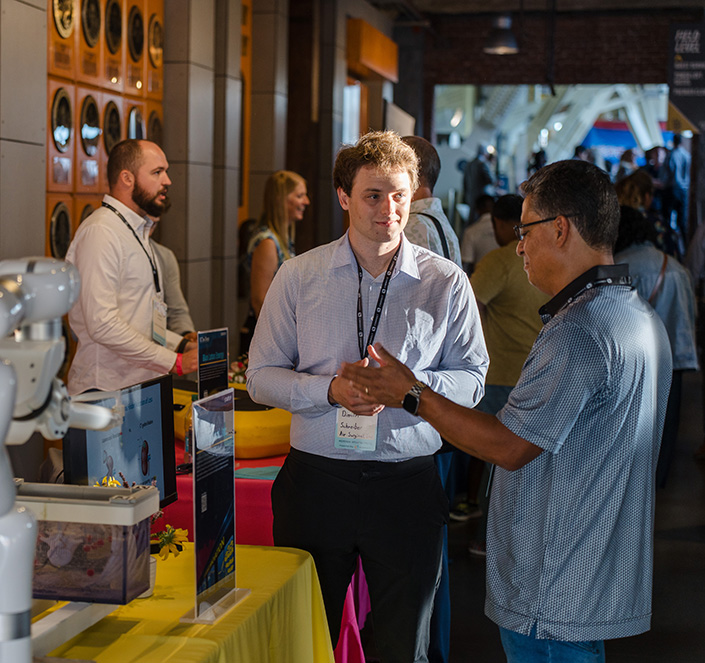 Dimitri Schreiber talks to attendee next to AirSurgical table