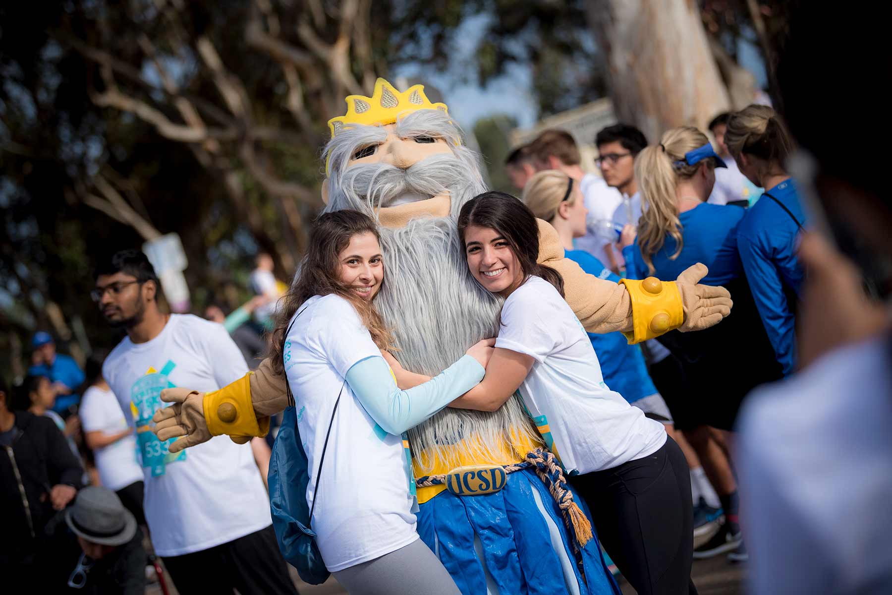 Student hugging King Triton mascot