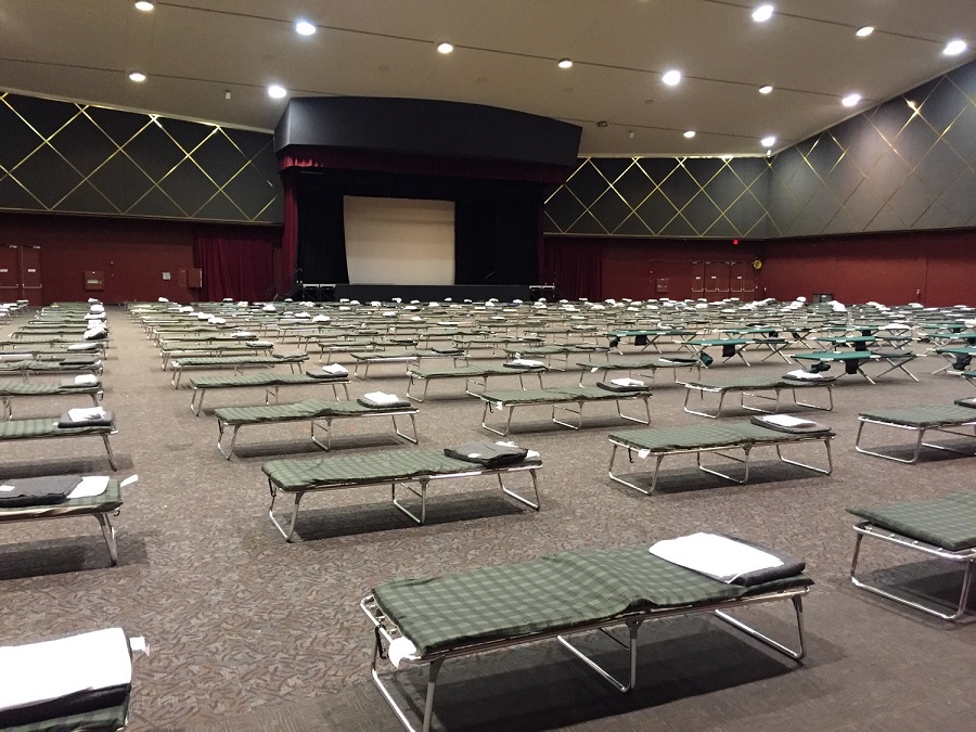 convention center full of beds 6 feet apart