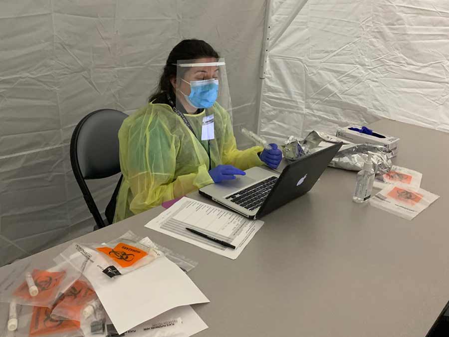 Dr. Elizabeth Sophy preparing to administer COVID-19 tests