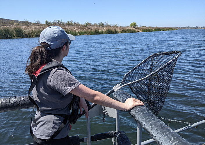 A woman conducts fieldwork at a popular fishing site.