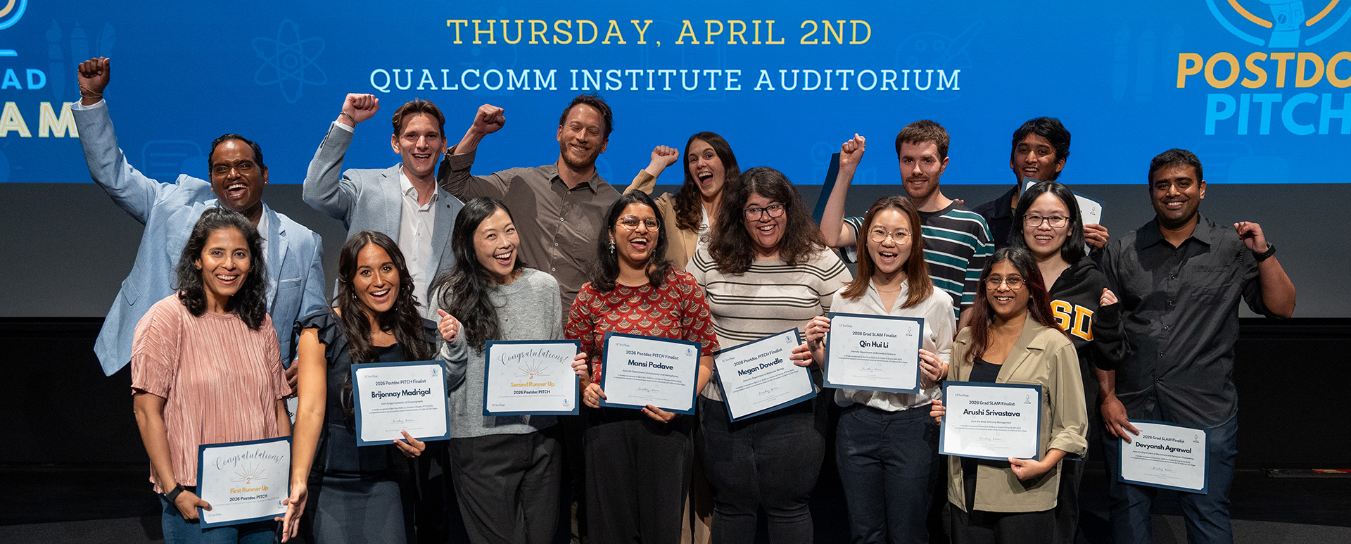 Group of people holding certificates on a stage