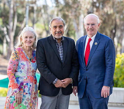 Three people standing together. 