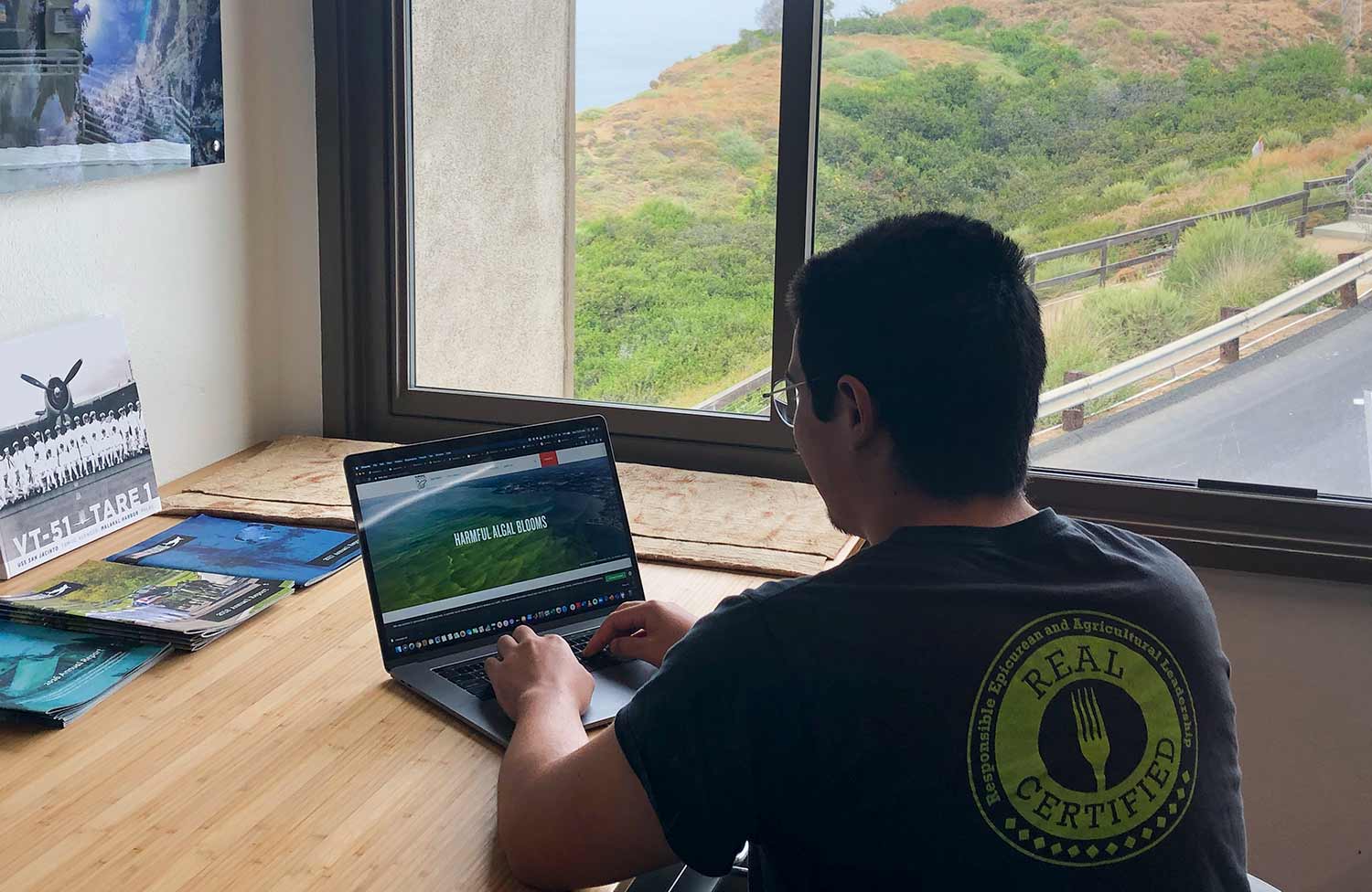 student on a laptop looking at information about algal blooms