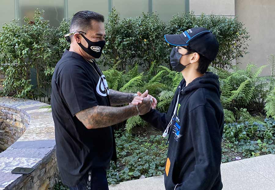 George Jimenez and Isaac Gonzalez reunite at the fountain outside Sulpizio Cardiovascular Center.e