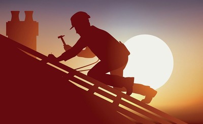 Roof workers working against a bright sun.