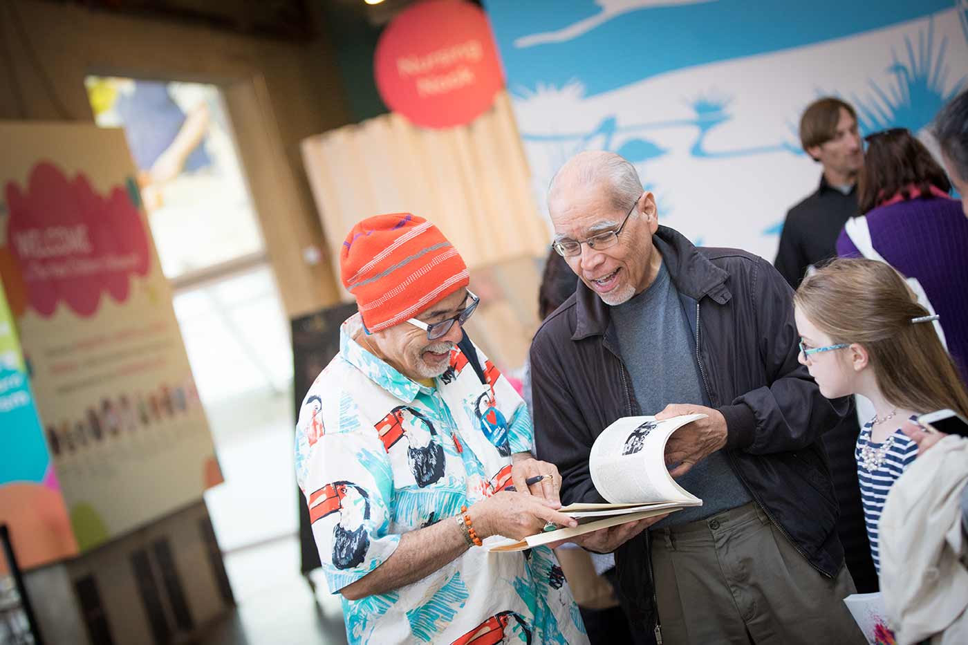 Juan Felipe Herrera talking with kids and parents