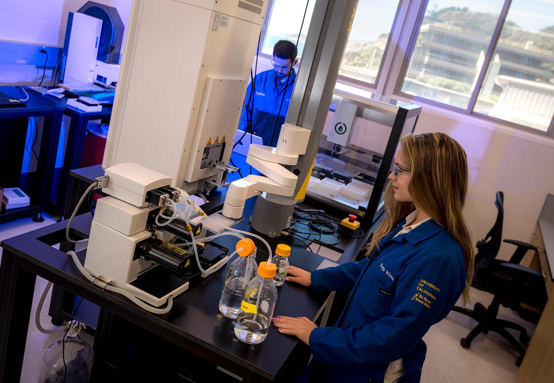 PhD student Kayla Wilson operates a new bulk reagent dispenser in the Illumina lab.