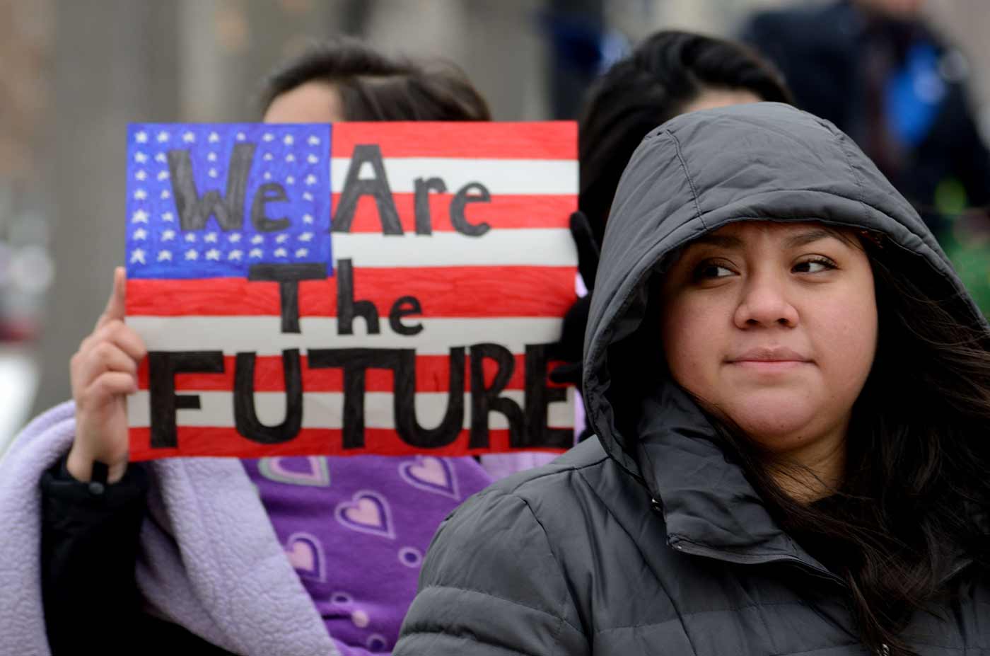 Women holding We Are the Future flag poster