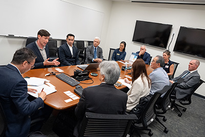 a group of people sit around a table