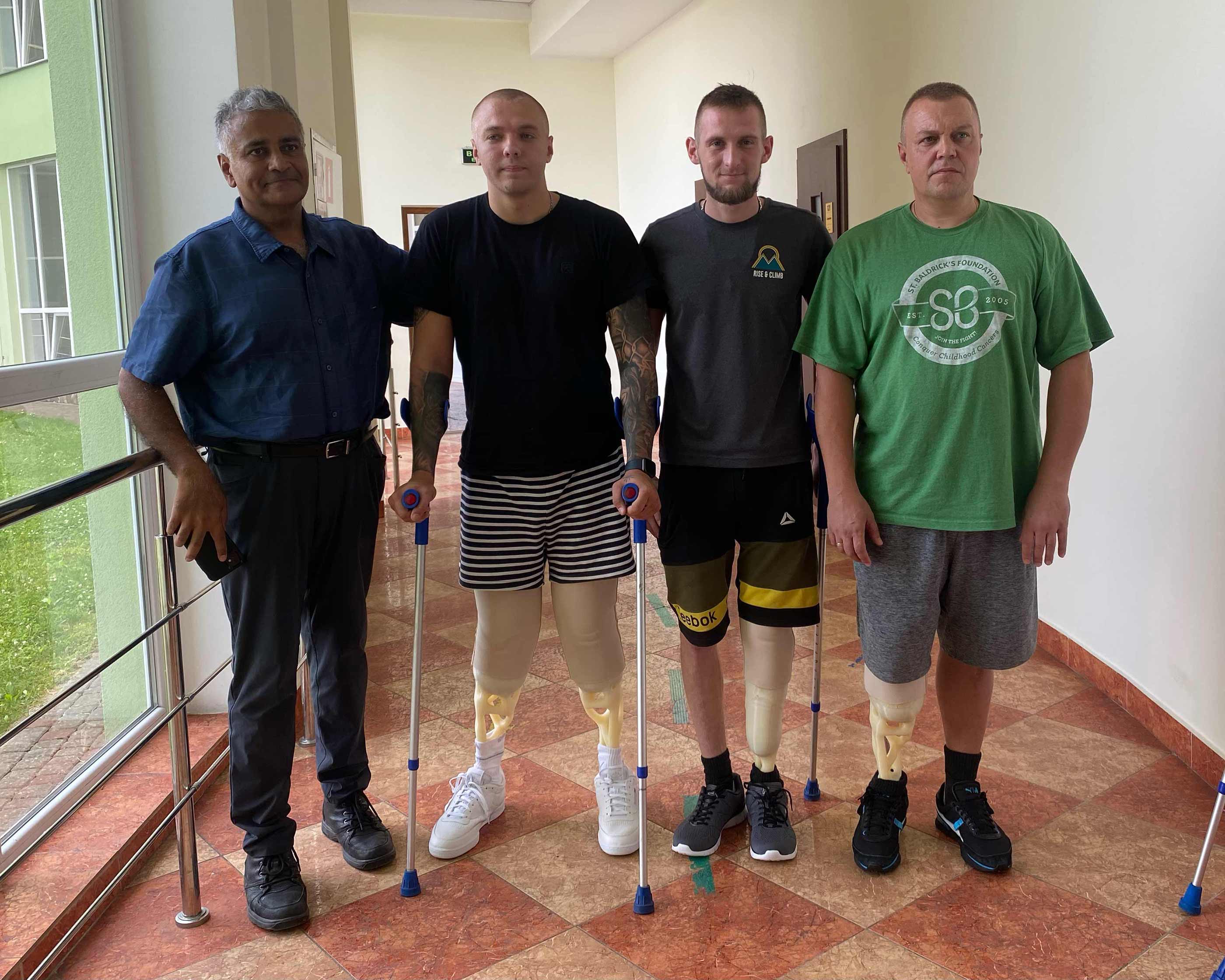 Dr. Monga with three of the patients who received prostheses from LIMBER.