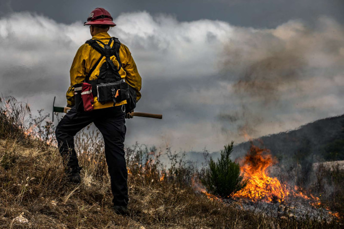 Firefighter supervising controlled burn