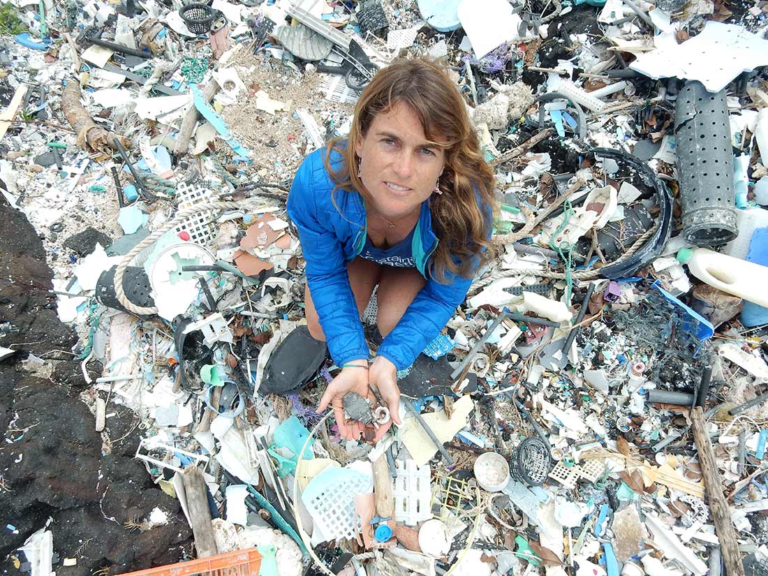 Sarah-Jeanne Royer kneeling down holding microplastics