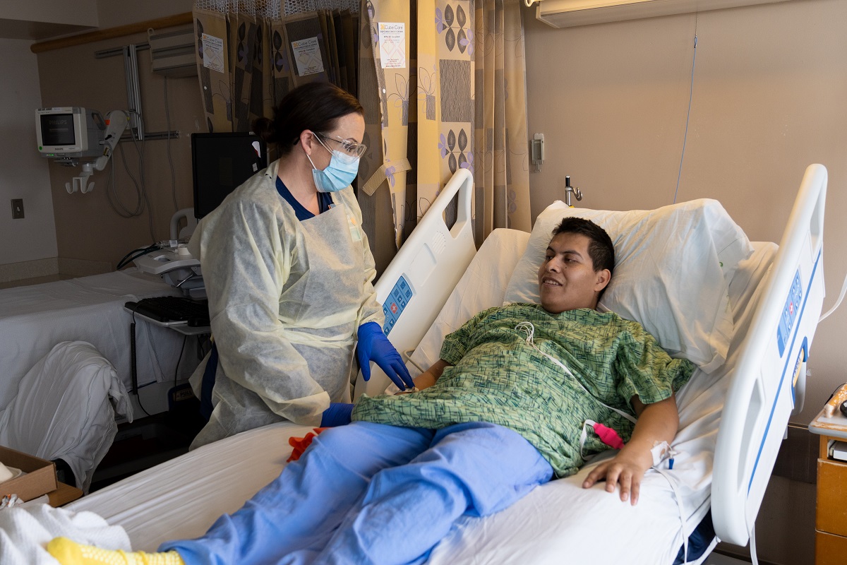 doctor talking to a patient in a hospital bed