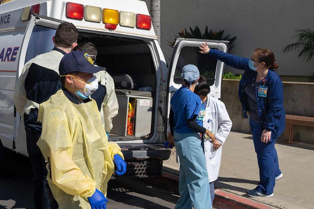 Lichtward helping transfer patient out of ambulance