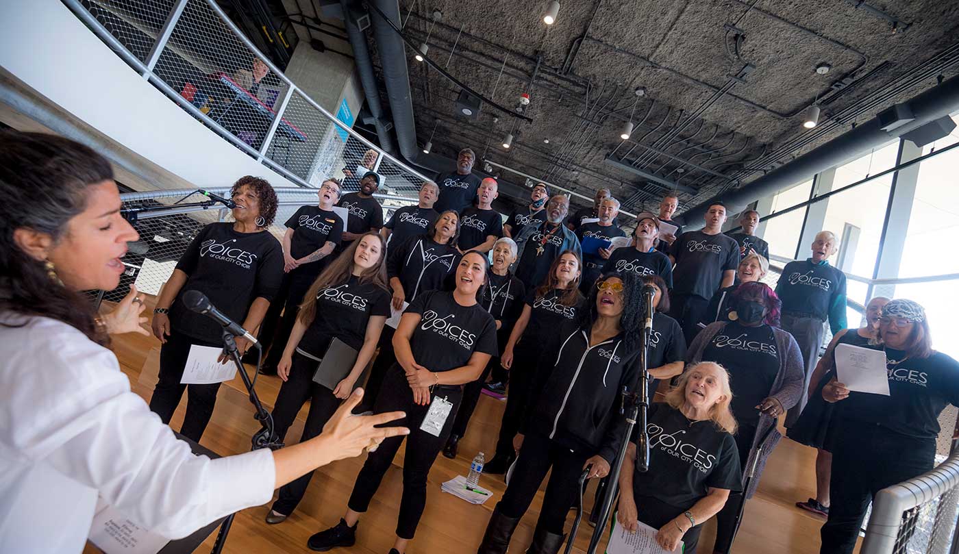 Voices of Our City Choir performed at the opening.