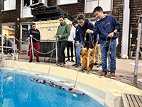 Students test their AUV and its sensors in a pool.