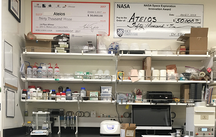 Lab with images of funding checks on wall
