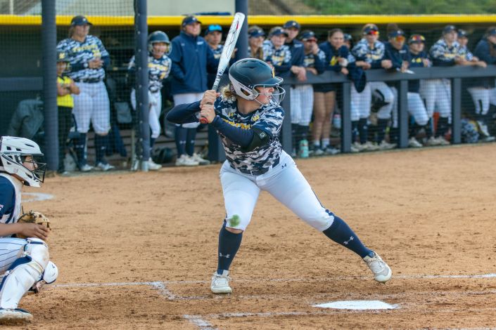 a softball player at bat