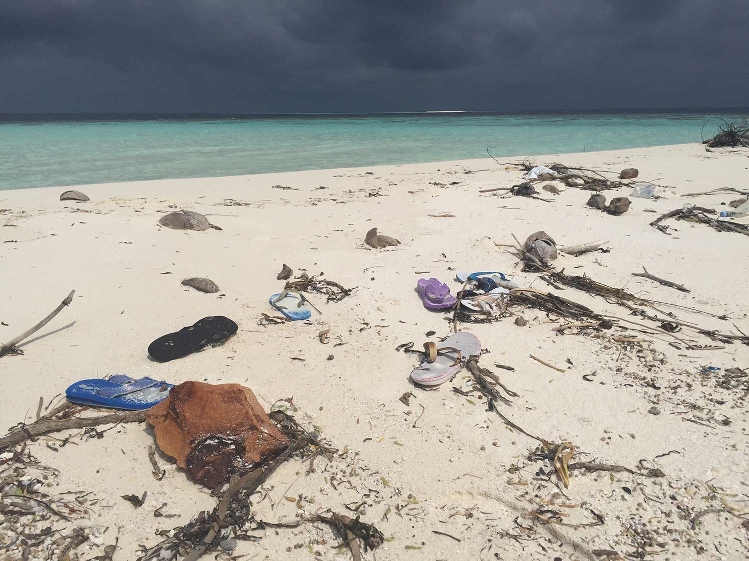 beach with trash flip flops.