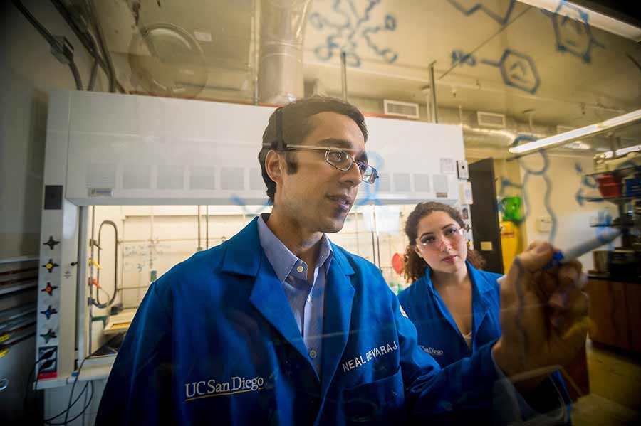 Professor Neal Devaraj with a student at the research lab