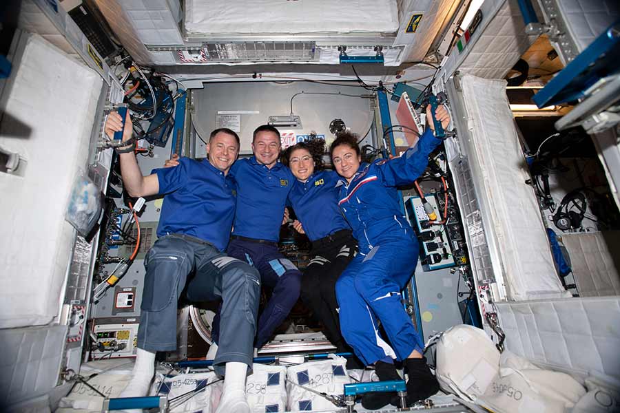 austronauts posing for picture in space station