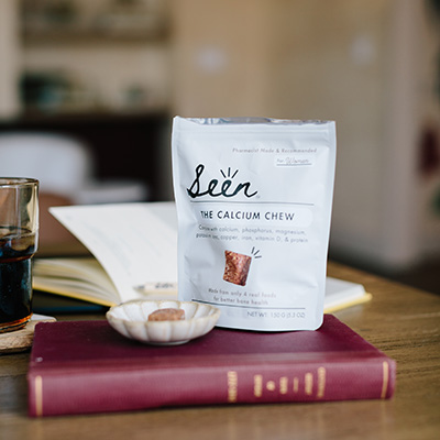 Package of Seen Calcium Chews on a book on a table