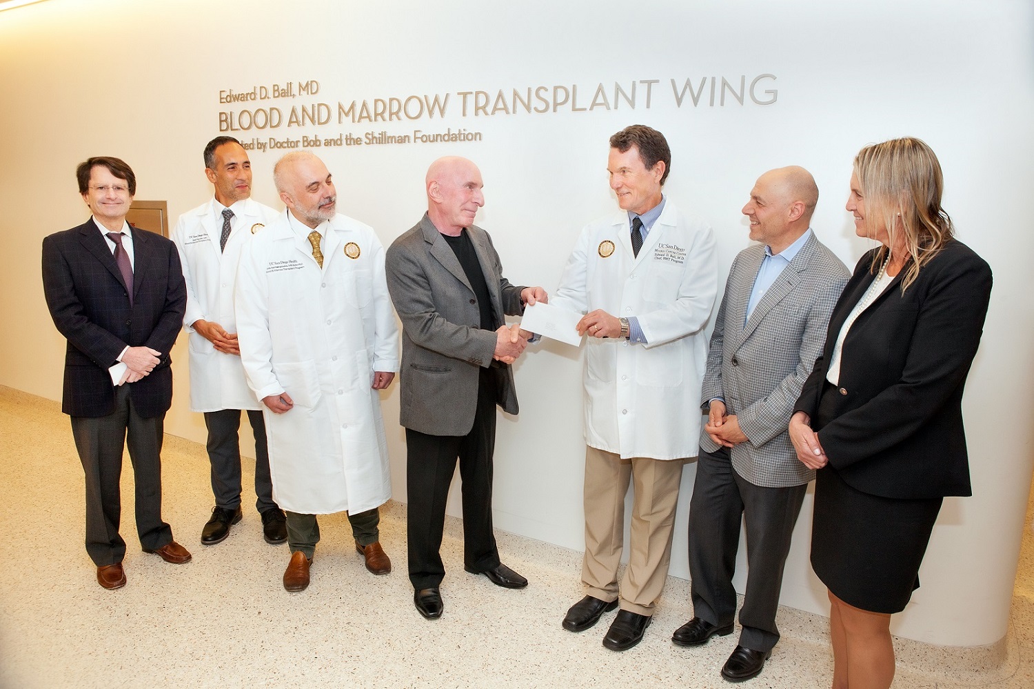Dr. Bob and Dr. Ball in front of new sign for Blood and Marrow Transplant Wing