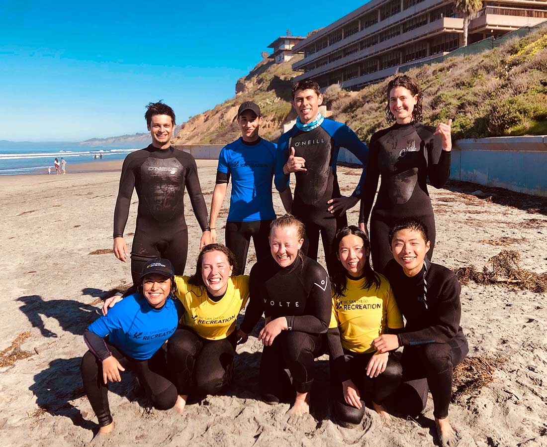 Francesca Hart on the beach with surfing students.