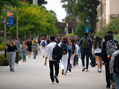 Students walking through the UC San Diego college campus.