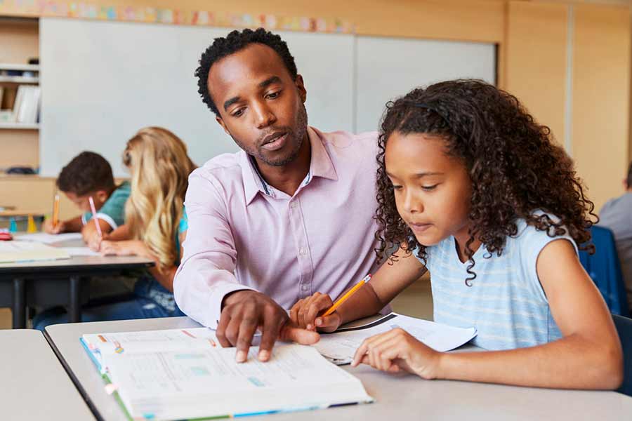 Adult teaching little girl