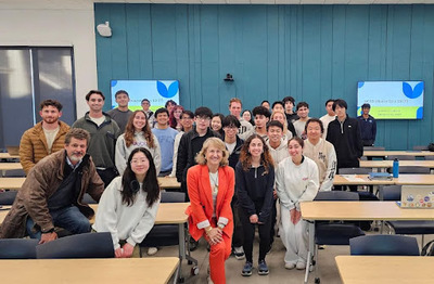 Students posing with Marc-Andreas Muendler (far left) professor and chair of the Department of Economics and alumna Leilani Latimer (center in red) 