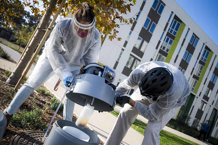 Smruthi Karthikeyan and Rob Knight pick up wastewater samples