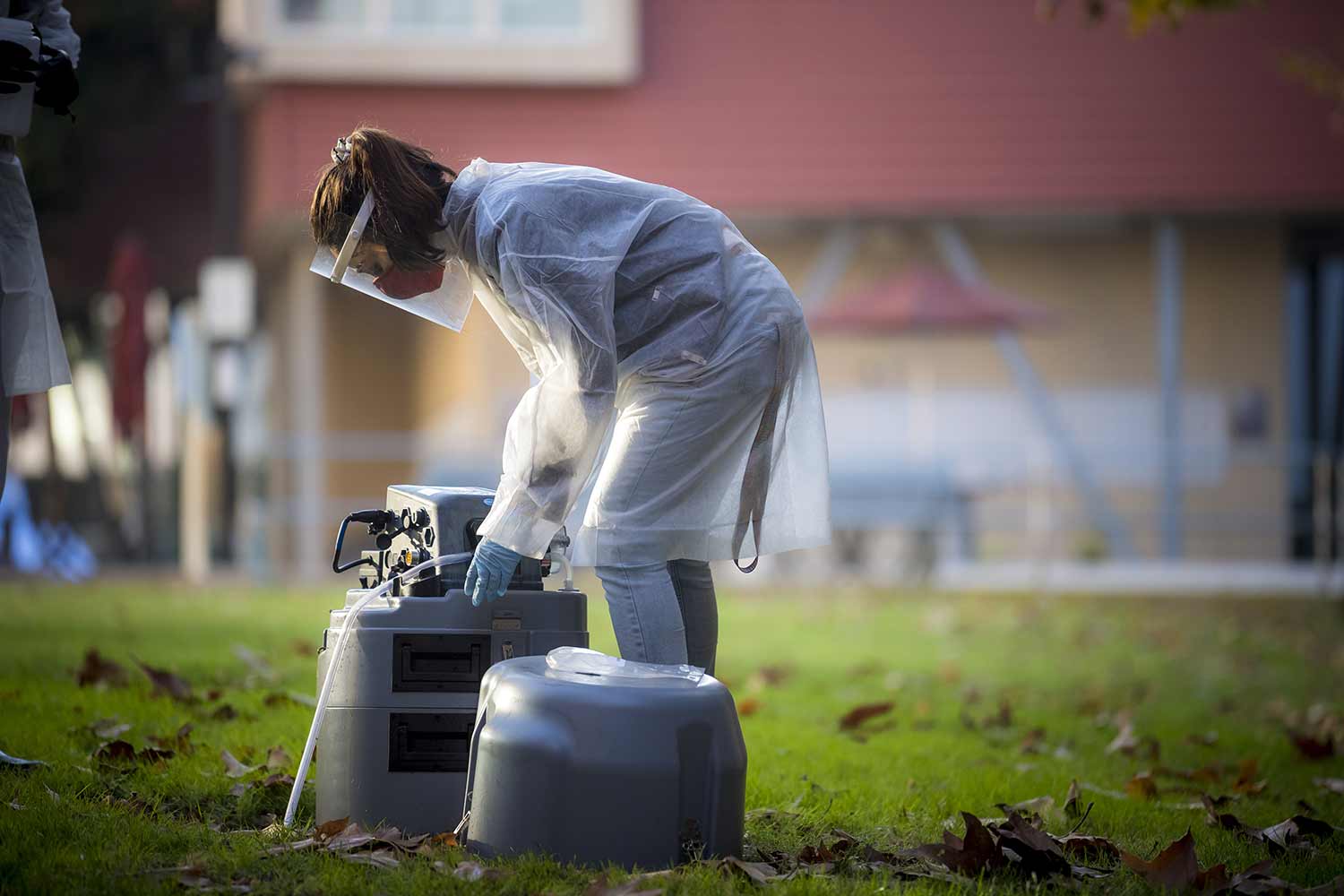 Smruthi Karthikeyan, PhD, picks up wastewater samples.